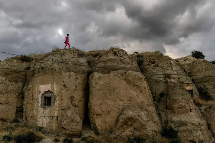 住在瓜地什的12岁女孩茱蒂丝（Judith）从一间洞穴屋的上方走过。数百年以来，这个地区一直是地下居民的住所。 PHOTOGRAPH BY TAMARA MER